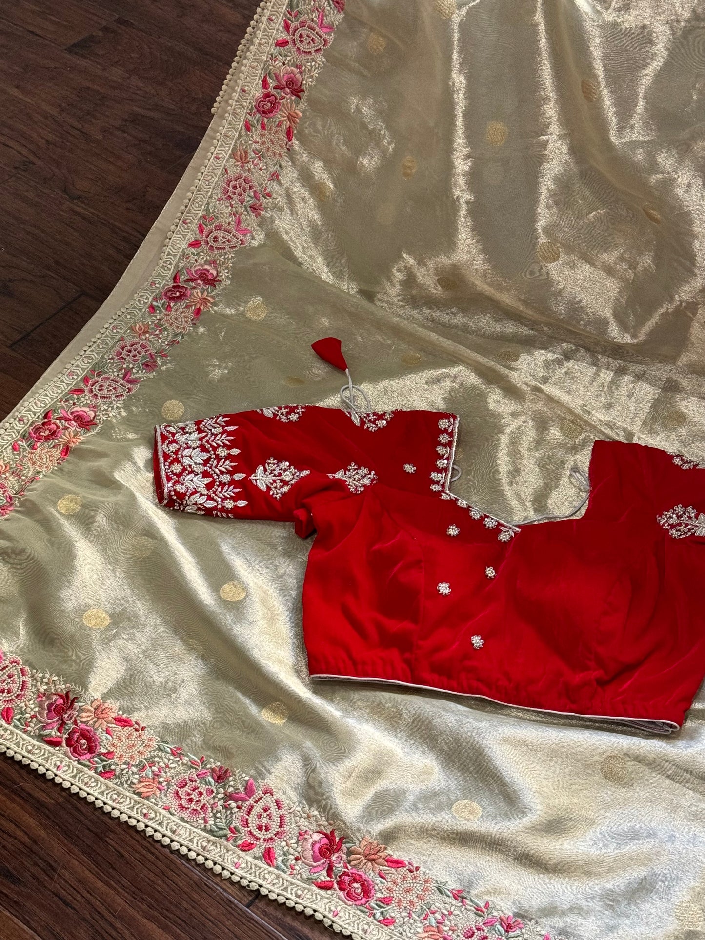 **New**Tissue saree with embroidery boarder paired with red velvet work blouse